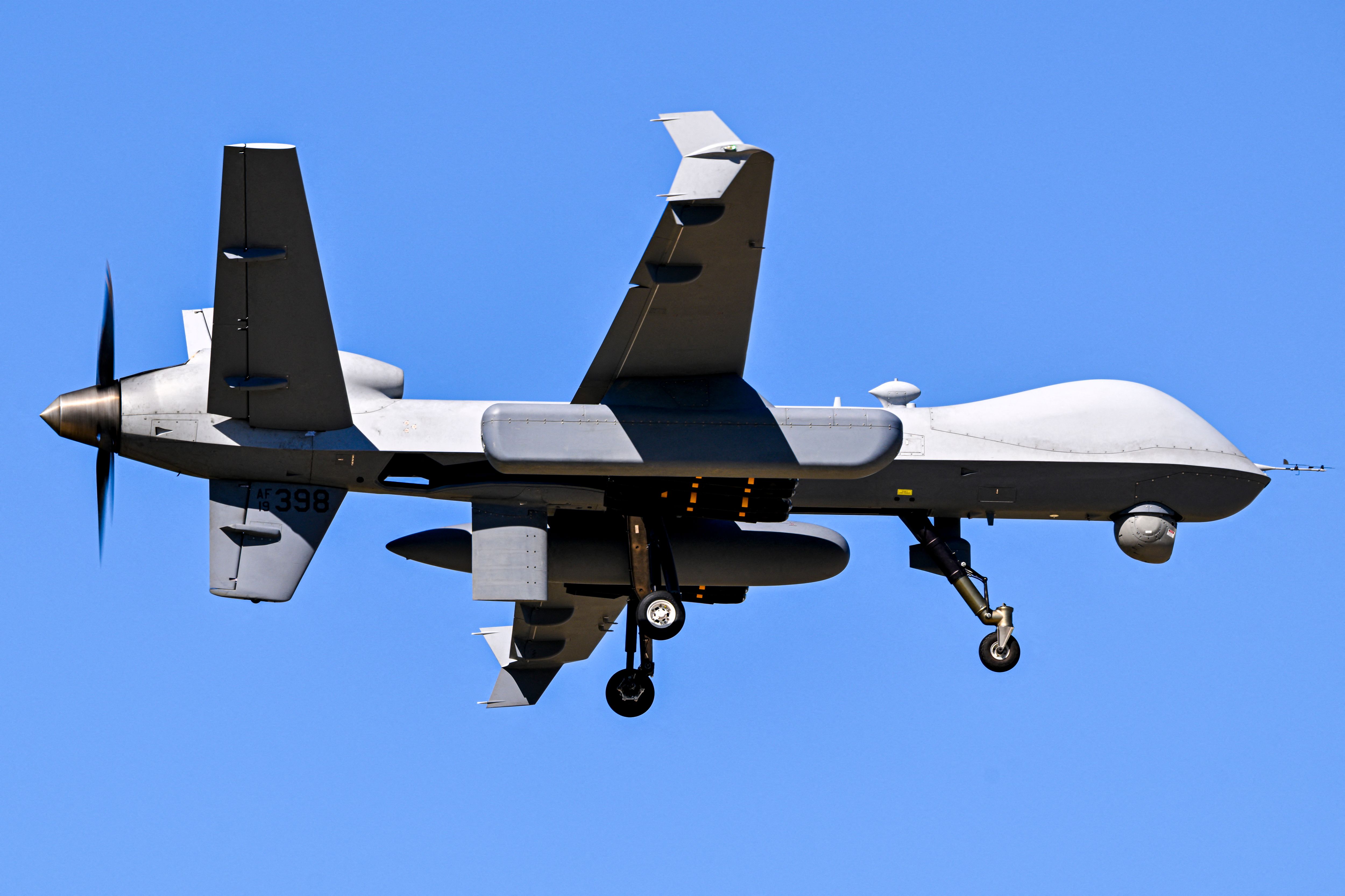 A US military MQ-9 Reaper drone approaches for landing at Rafael Hernandez Airport in Aguadilla, Puerto Rico, on December 29, 2025. The United States has deployed a major military force in the Caribbean and has recently intercepted oil tankers as part of a naval blockade against Venezuelan vessels it considers to be under sanctions. Since September, US forces have launched dozens of air strikes on boats that Washington alleges, without showing evidence, were transporting drugs. More than 100 people have been killed. (Photo by Miguel J. Rodriguez Carrillo / AFP)