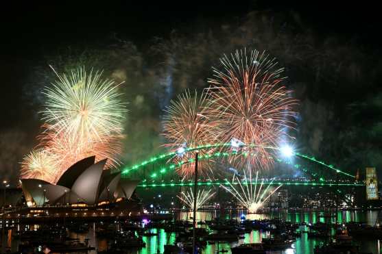 Fireworks light up the midnight sky over Sydney Harbour Bridge and Sydney Opera House during New Years Day celebrations in Sydney on January 1, 2026. (Photo by Saeed KHAN / AFP)