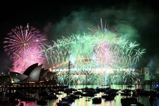 Fireworks light up the midnight sky over Sydney Harbour Bridge and Sydney Opera House during New Years Day celebrations in Sydney on January 1, 2026. (Photo by Saeed KHAN / AFP)