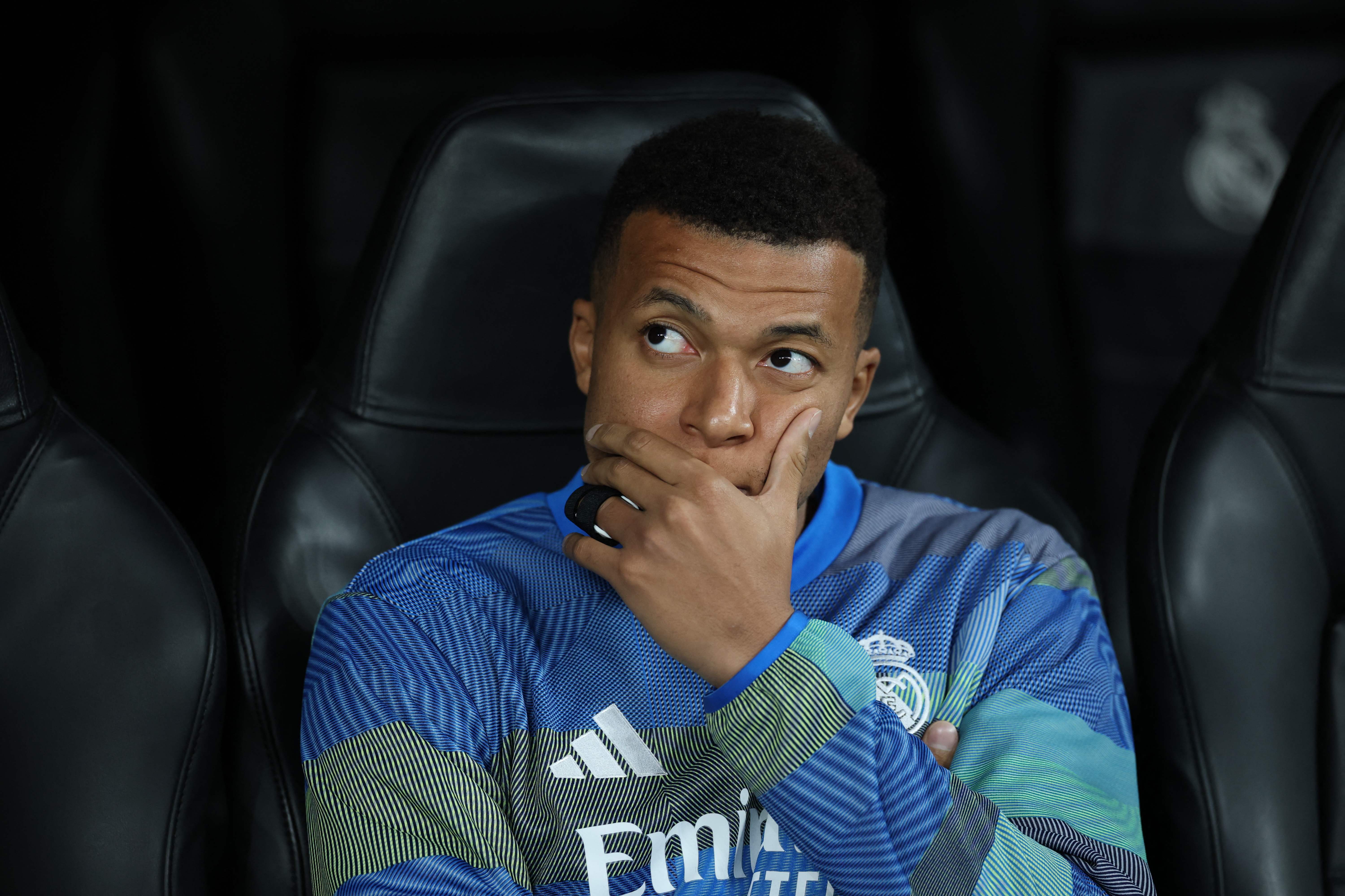 (FILES) Real Madrid's French forward #10 Kylian Mbappe sits on the bench during the UEFA Champions League league phase day 6 football match between Real Madrid CF and Manchester City at Santiago Bernabeu Stadium in Madrid on December 10, 2025. Real Madrid's French star Kylian Mbappe, sidelined with a knee injury, will be out for at least three weeks, a source close to the player told AFP, on December 31, 2025. (Photo by Thomas COEX / AFP)