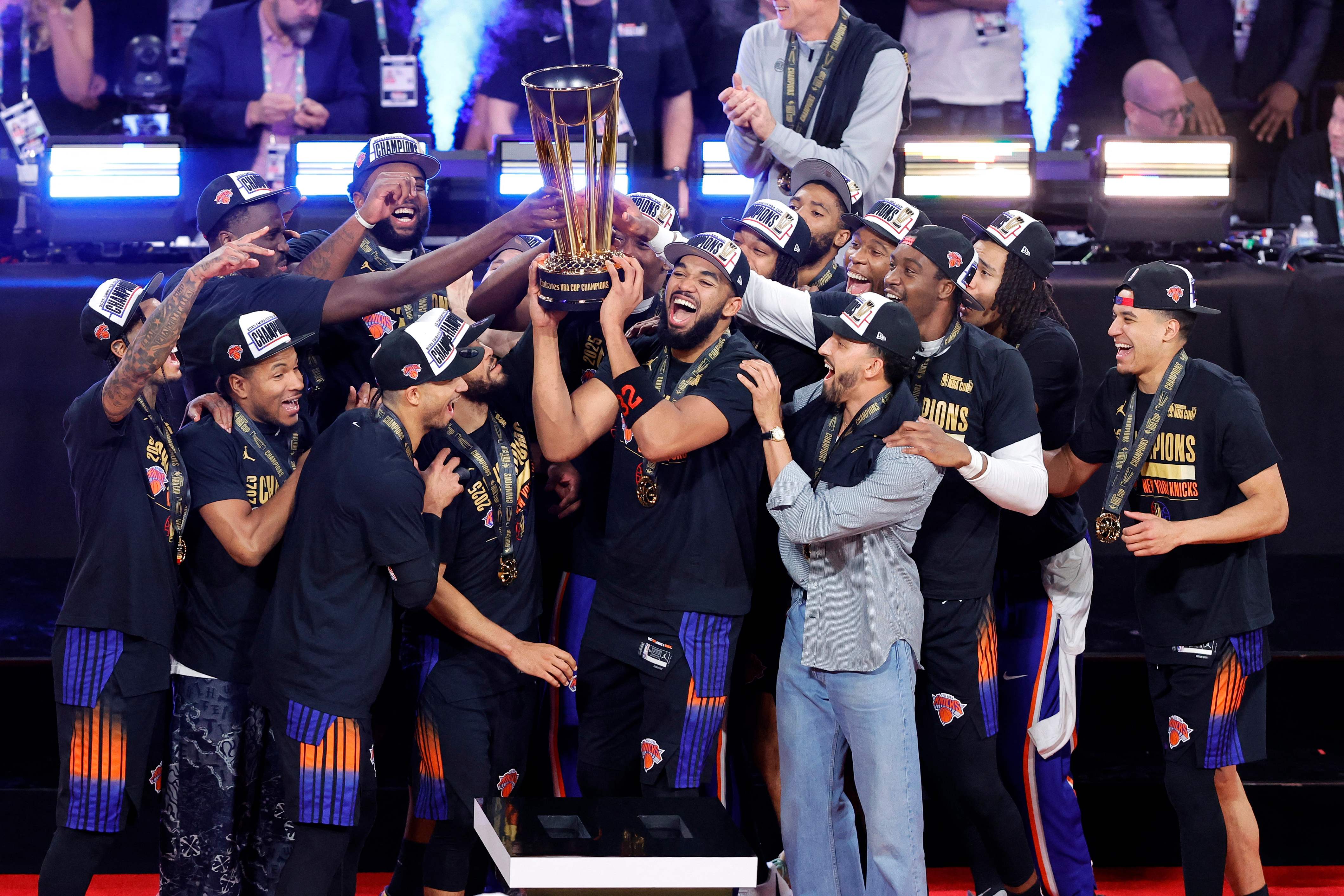 LAS VEGAS, NEVADA - DECEMBER 16: The New York Knicks celebrate with the trophy after the Knicks defeated the San Antonio Spurs 124-113 in the Emirates NBA Cup Championship game at T-Mobile Arena on December 16, 2025 in Las Vegas, Nevada.   Steve Marcus/Getty Images/AFP (Photo by Steve Marcus / GETTY IMAGES NORTH AMERICA / Getty Images via AFP)