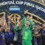 PSG's players celebrate on the podium after winning the 2025 FIFA Intercontinental Cup final football match between Paris Saint-Germain (PSG) and CR Flamengo at the Ahmad bin Ali Stadium in Al-Rayyan on the outskirts of Doha on December 17, 2025. (Photo by Karim JAAFAR / AFP)