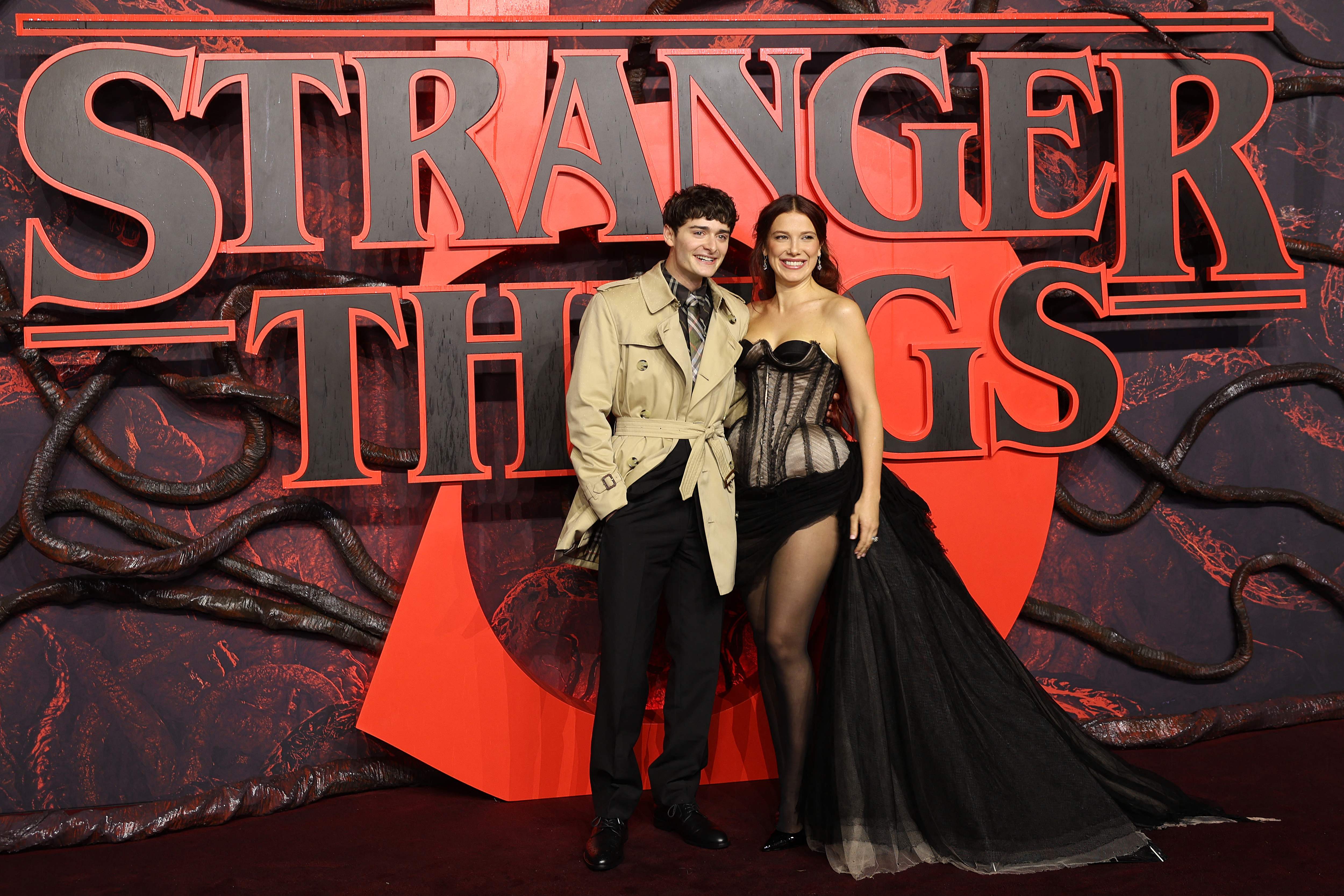 (FILES) US actor Noah Schnapp (L) and British actor Millie Bobby Brown arrives to attend the UK special screening of the Netflix series 'Stranger Things 5', at Leicester Square in central London on November 13, 2025. The hit fantasy series Stranger Things returns to Netflix on December 26, 2025 for three new episodes of the fifth and final season, before the grand finale on January 1st. (Photo by Toby Shepheard / AFP)