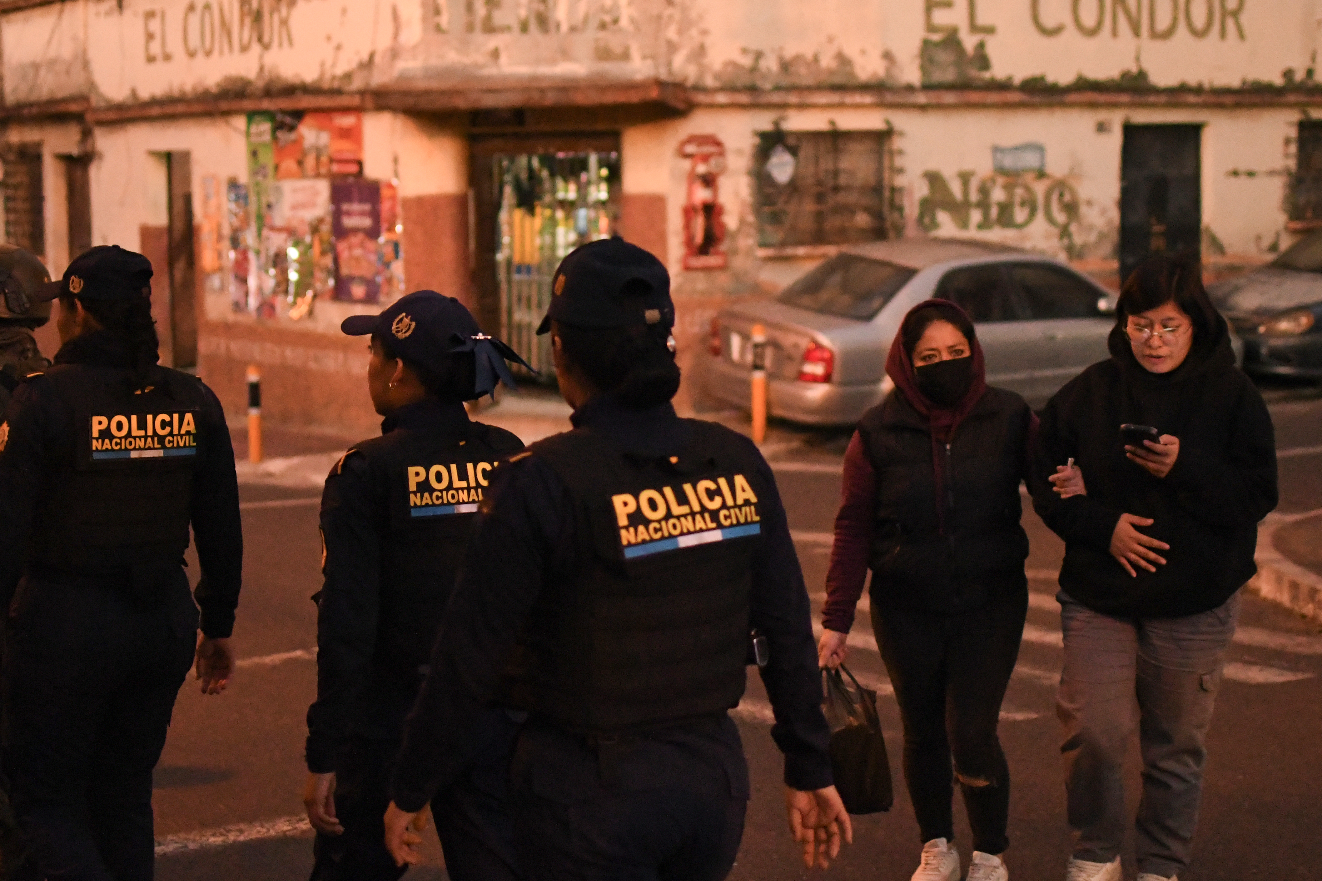 ACOMPAÑA CRÓNICA: GUATEMALA VIOLENCIA AME7697. CIUDAD DE GUATEMALA (GUATEMALA), 23/01/2026.- Integrantes de la Policía Nacional Civil (PNC) custodian una calle en el barrio El Gallito este jueves, en Ciudad de Guatemala (Guatemala). Al barrio El Gallito, situado a dos kilómetros del centro de la Ciudad de Guatemala, se puede entrar con el permiso de las estructuras criminales que dominan el área o con las fuerzas de seguridad, de lo contrario, te arriesgas a no salir con vida, como le sucedió hace tres días a dos jóvenes tiroteados. EFE/ Alex Cruz