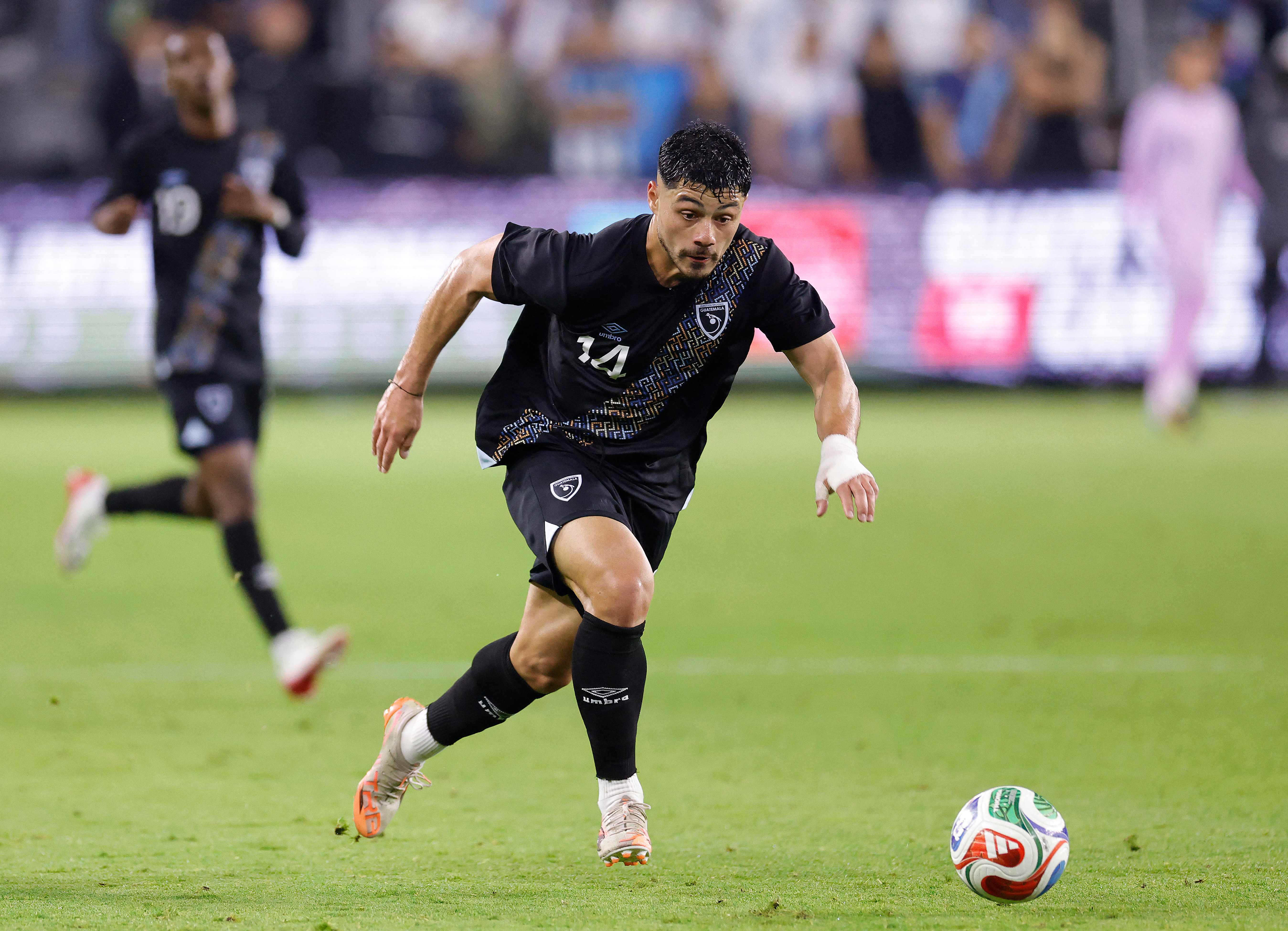LOS ANGELES, CALIFORNIA - JANUARY 17: Darwin Lom #14 of Guatemala controls the ball against Canada in the first half of a International Friendly at BMO Stadium on January 17, 2026 in Los Angeles, California.   Ronald Martinez/Getty Images/AFP (Photo by RONALD MARTINEZ / GETTY IMAGES NORTH AMERICA / Getty Images via AFP)