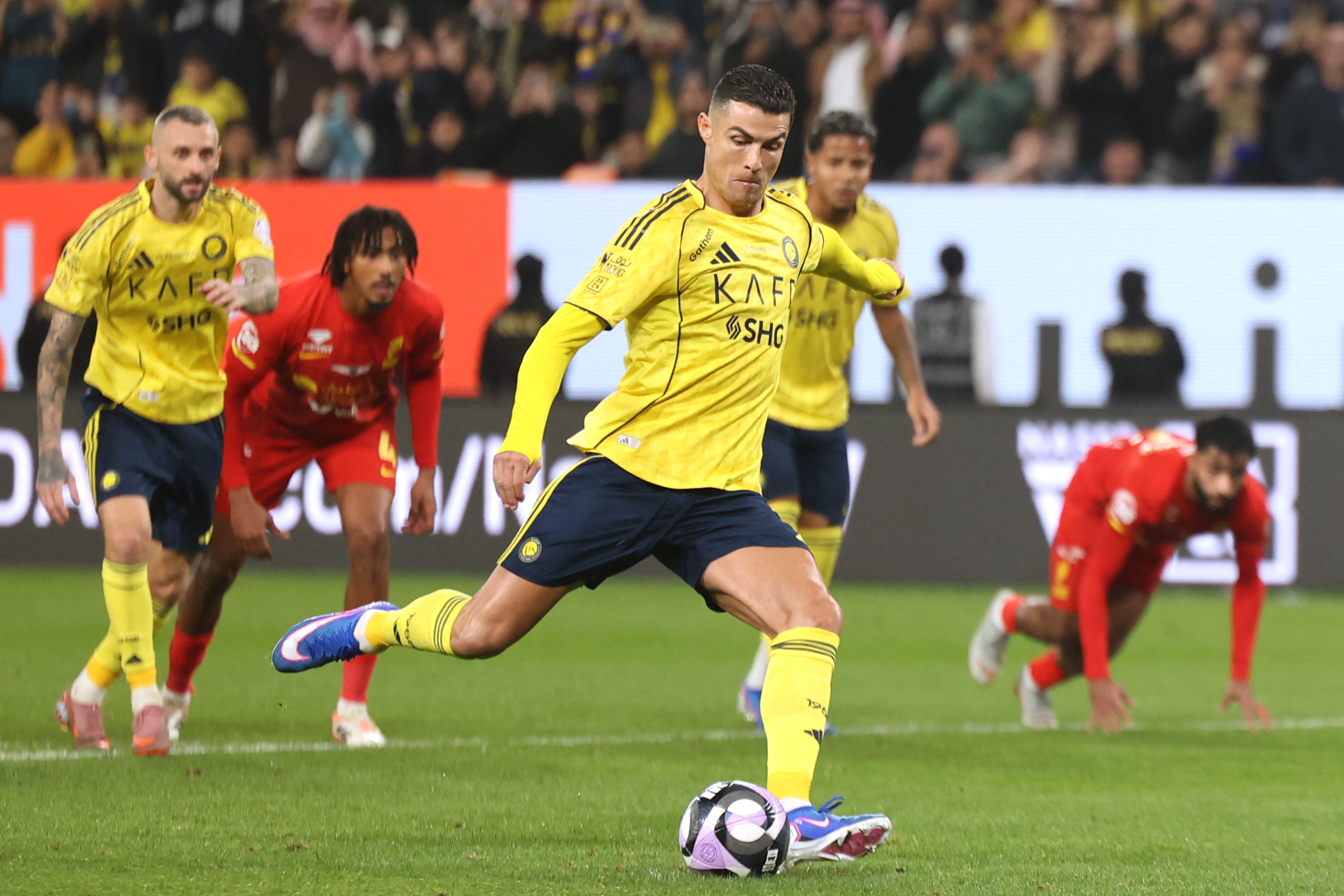Nassr's Portuguese forward #07 Cristiano Ronaldo shoots from the penalty spot to score his team's first goal during the Saudi Pro League football match between Al-Nassr FC and Al-Qadsiah at al-Awwal Park stadium in Riyadh on January 8, 2026. (Photo by Fayez NURELDINE / AFP)