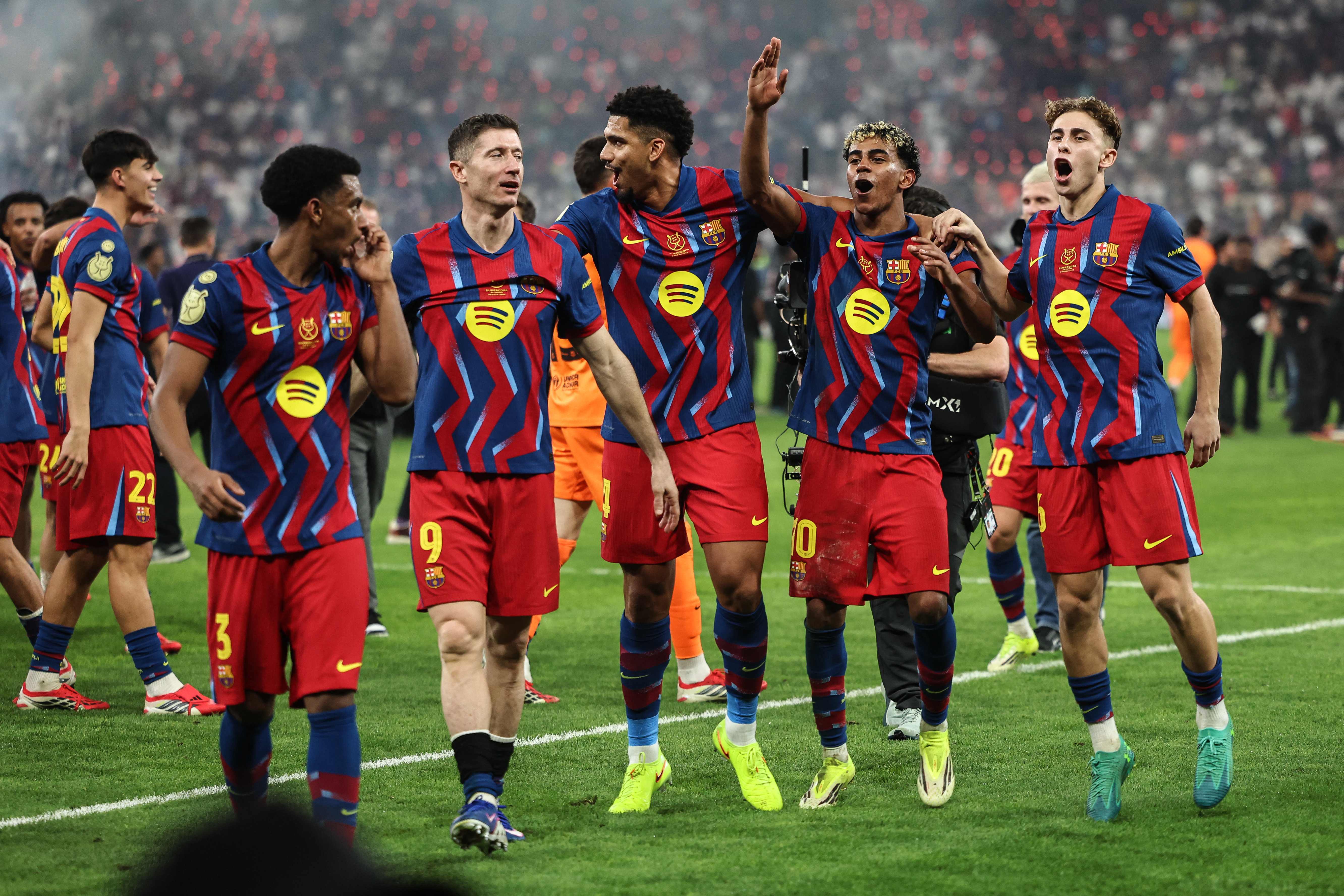 Barcelona's players celebrate after winning the Spanish Super Cup final football match between FC Barcelona and Real Madrid at the King Abdullah Stadium in Jeddah on January 11, 2026. (Photo by Fadel SENNA / AFP)