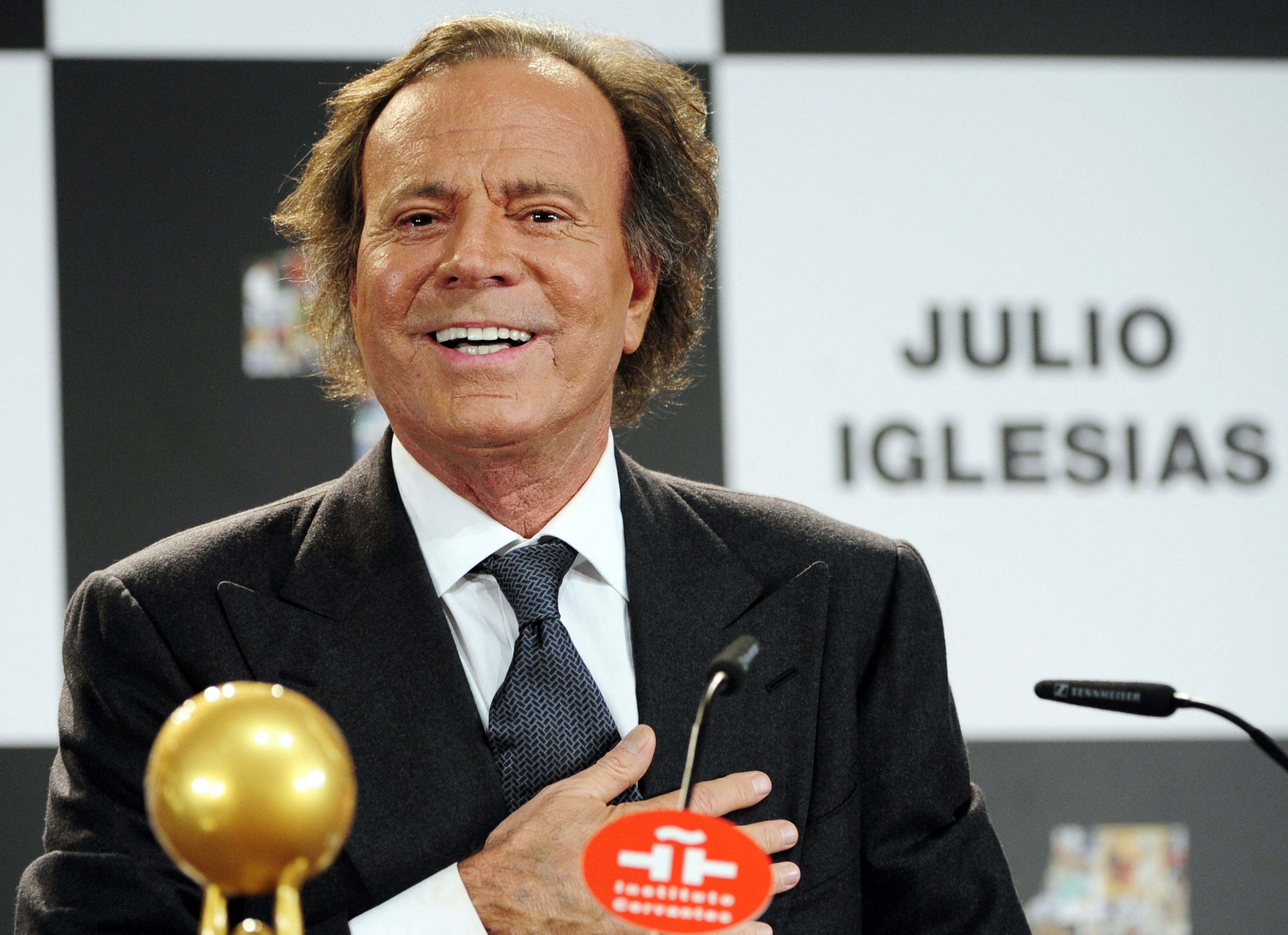 (FILES) Spanish singer Julio Iglesias speaks after receiving the Award for artist who has sold the most records in Spain  and the Latino Artist Award for the most albums sold in the world at Cervantes Institute in Madrid on December 16, 2011. Two former employees of Julio Iglesias sue him before the Spanish justice, after denouncing in a journalistic investigation published this January 13, 2026 alleged assaults and sexual harassment by the Spanish singer. Legal sources confirmed to AFP that a complaint against Iglesias was filed on January 5 and is being examined. (Photo by Javier SORIANO / AFP)