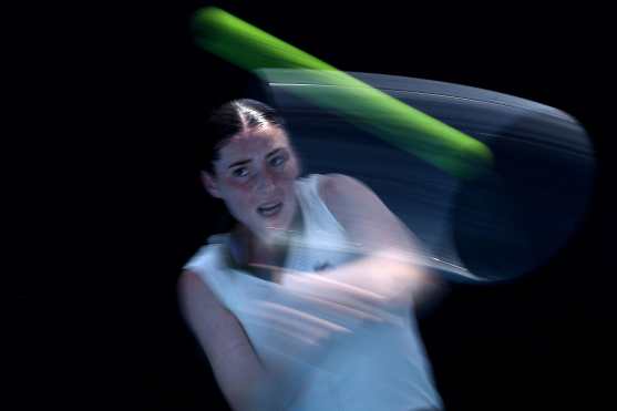 A slow shutter speed exposure captures France's Elsa Jacquemot as she hits a return to Kazakhstan's Yulia Putintseva during their women's singles match on day four of the Australian Open tennis tournament in Melbourne on January 21, 2026. (Photo by Martin KEEP / AFP) / -- IMAGE RESTRICTED TO EDITORIAL USE - STRICTLY NO COMMERCIAL USE --