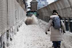 NEW YORK CITY - JANUARY 26: People walk through the snow on the Manhattan Bridge after a storm left nearly one foot of snow on January 26, 2026, in New York City. A massive winter storm has brought frigid temperatures, ice, and snow to millions of Americans across the nation. The storm has left at least 10 people dead and hundreds of thousands without power.   Spencer Platt/Getty Images/AFP (Photo by SPENCER PLATT / GETTY IMAGES NORTH AMERICA / Getty Images via AFP)