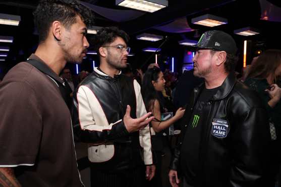 DAYTONA BEACH, FLORIDA - FEBRUARY 15: NASCAR Puca Nacua, Los Angeles Rams wide receiver (L) and Hall of Famer Kurt Busch talk on during the drivers meeting prior to the NASCAR Cup Series Daytona 500 at Daytona International Speedway on February 15, 2026 in Daytona Beach, Florida.   Chris Graythen/Getty Images/AFP (Photo by Chris Graythen / GETTY IMAGES NORTH AMERICA / Getty Images via AFP)
