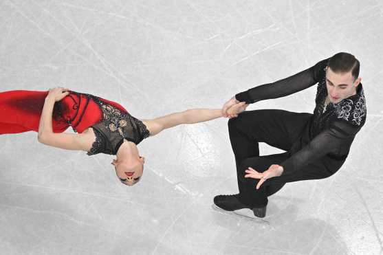 Georgia's Anastasiia Metelkina and Georgia's Luka Berulava compete in the figure skating pair skating short program during the Milano Cortina 2026 Winter Olympic Games at Milano Ice Skating Arena in Milan on February 15, 2026. (Photo by Antonin THUILLIER / AFP)