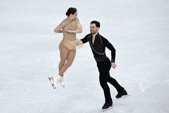 Canada's Deanna Stellato-Dudek and Canada's Maxime Deschamps compete in the figure skating pair skating short program during the Milano Cortina 2026 Winter Olympic Games at Milano Ice Skating Arena in Milan on February 15, 2026. (Photo by WANG Zhao / AFP)