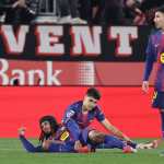Barcelona players react after conceding a goal from Girona's Spanish midfielder #08 Fran Beltran (out of frame) during the Spanish league football match between Girona FC and FC Barcelona at Montilivi Stadium in Girona on February 16, 2026. (Photo by Josep LAGO / AFP)
