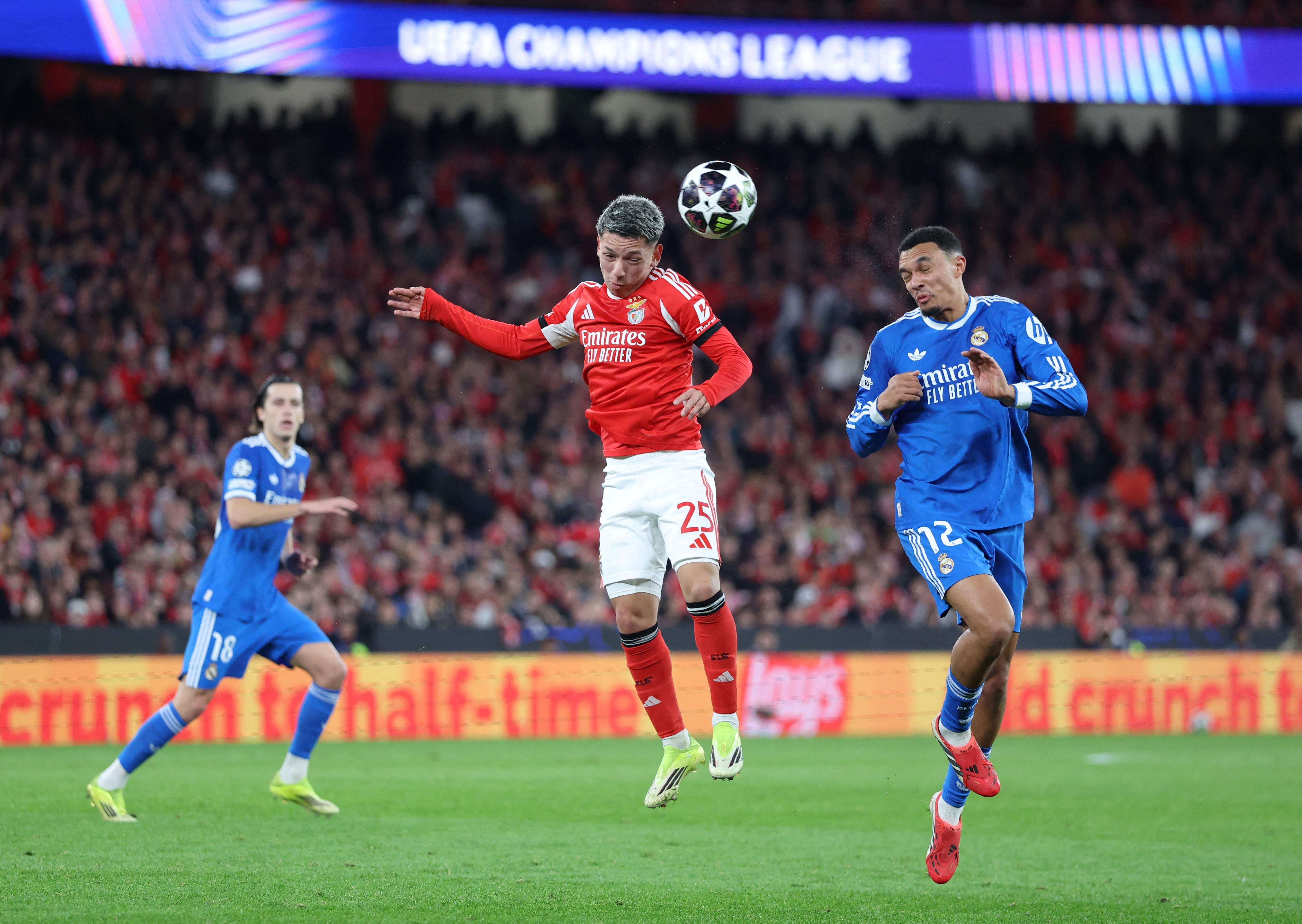 SL Benfica's Argentine forward #25 Gianluca Prestianni jumps for the ball next to Real Madrid's English defender #12 Trent Alexander-Arnold during the UEFA Champions League knockout round play-off first leg football match between SL Benfica and Real Madrid CF at Estadio da Luz in Lisbon on February 17, 2026. (Photo by PATRICIA DE MELO MOREIRA / AFP)