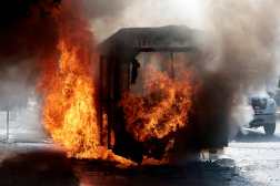 A bus set on fire by organised crime groups in response to an operation in Jalisco to arrest a high-priority security target, burns at one of the main avenues in Zapopan, state of Jalisco, Mexico, on February 22, 2026. Armed civilians blocked several roads in the state of Jalisco, in western Mexico, following an operation by federal forces in the town of Tapalpa, local authorities reported. Jalisco, which will host four matches of the upcoming 2026 World Cup, is home to the powerful Jalisco New Generation Cartel (CJNG), and has been rocked by several episodes of violence in recent years. (Photo by Ulises Ruiz / AFP)