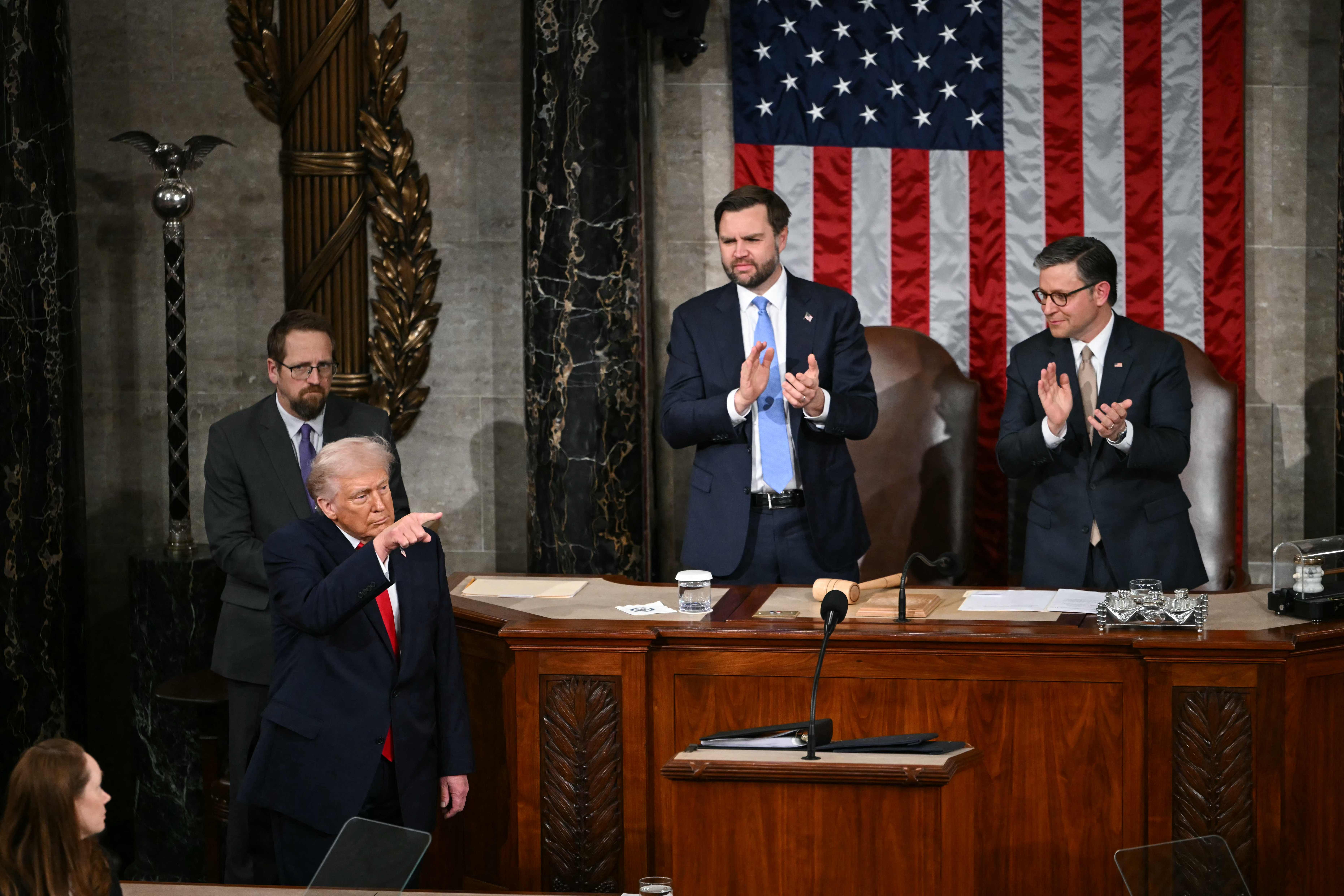 US President Donald Trump gestures as he concludes his remarks during the State of the Union address in the House Chamber of the US Capitol in Washington, DC, on February 24, 2026. (Photo by ANDREW CABALLERO-REYNOLDS / AFP)
