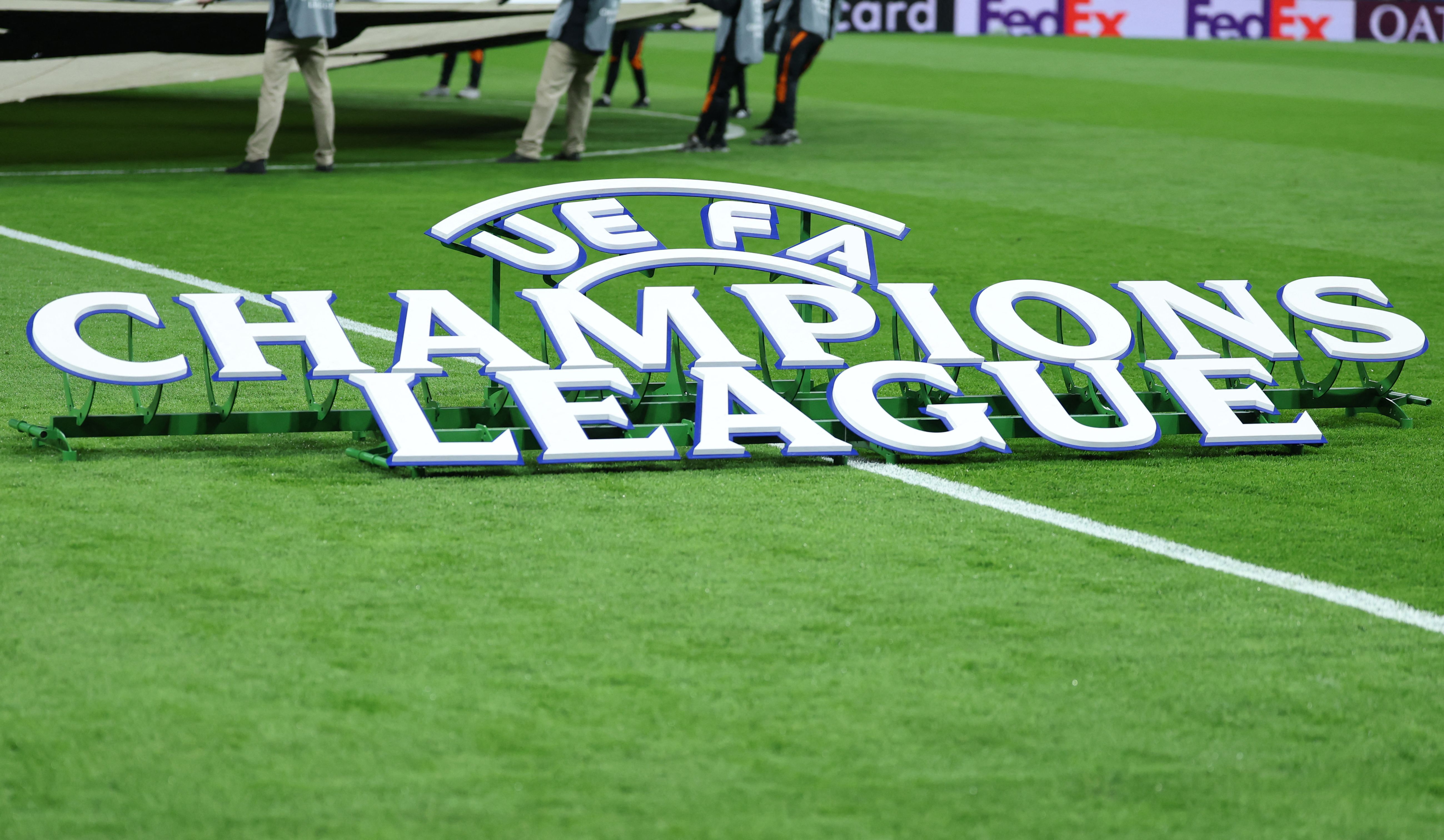 The Champions League logo is pictured on the pitch before the UEFA Champions League knockout round play-off second leg football match between Real Madrid CF and SL Benfica at Santiago Bernabeu Stadium in Madrid on February 25, 2026. (Photo by Thomas COEX / AFP)