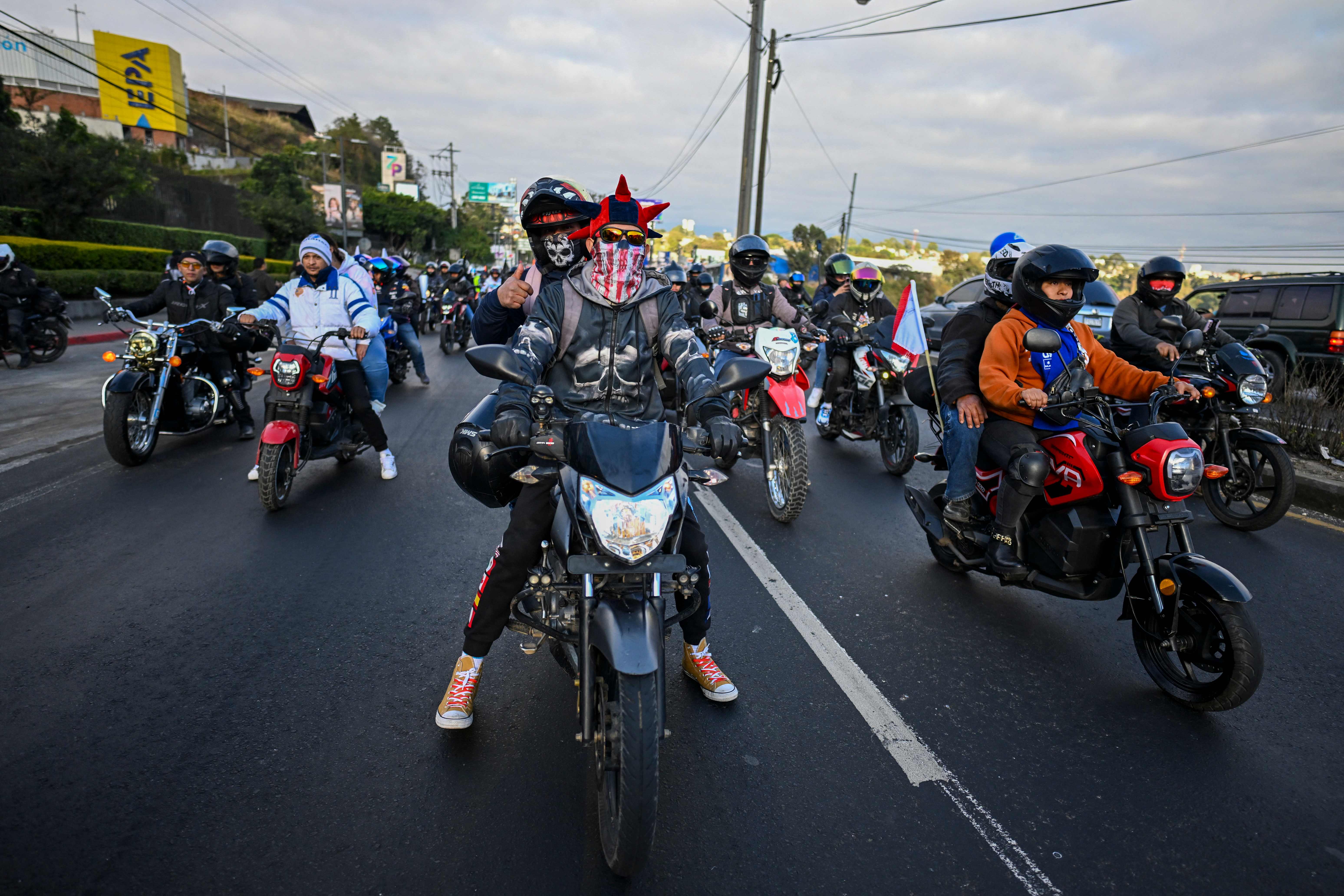 Bikers take part in the "Caravana del Zorro" (Caravan of the Fox) from Constitution Square in Guatemala City to Esquipulas, 222 km eastward, to see the Black Christ image, on February 7, 2026. Thousands of motorcyclists joined the pilgrimage to see a 16th-century carved black image of Jesus Christ in a basilica in the town of Esquipulas --a 64-year-old tradition that is part of the country's intangible cultural heritage. (Photo by JOHAN ORDONEZ / AFP)