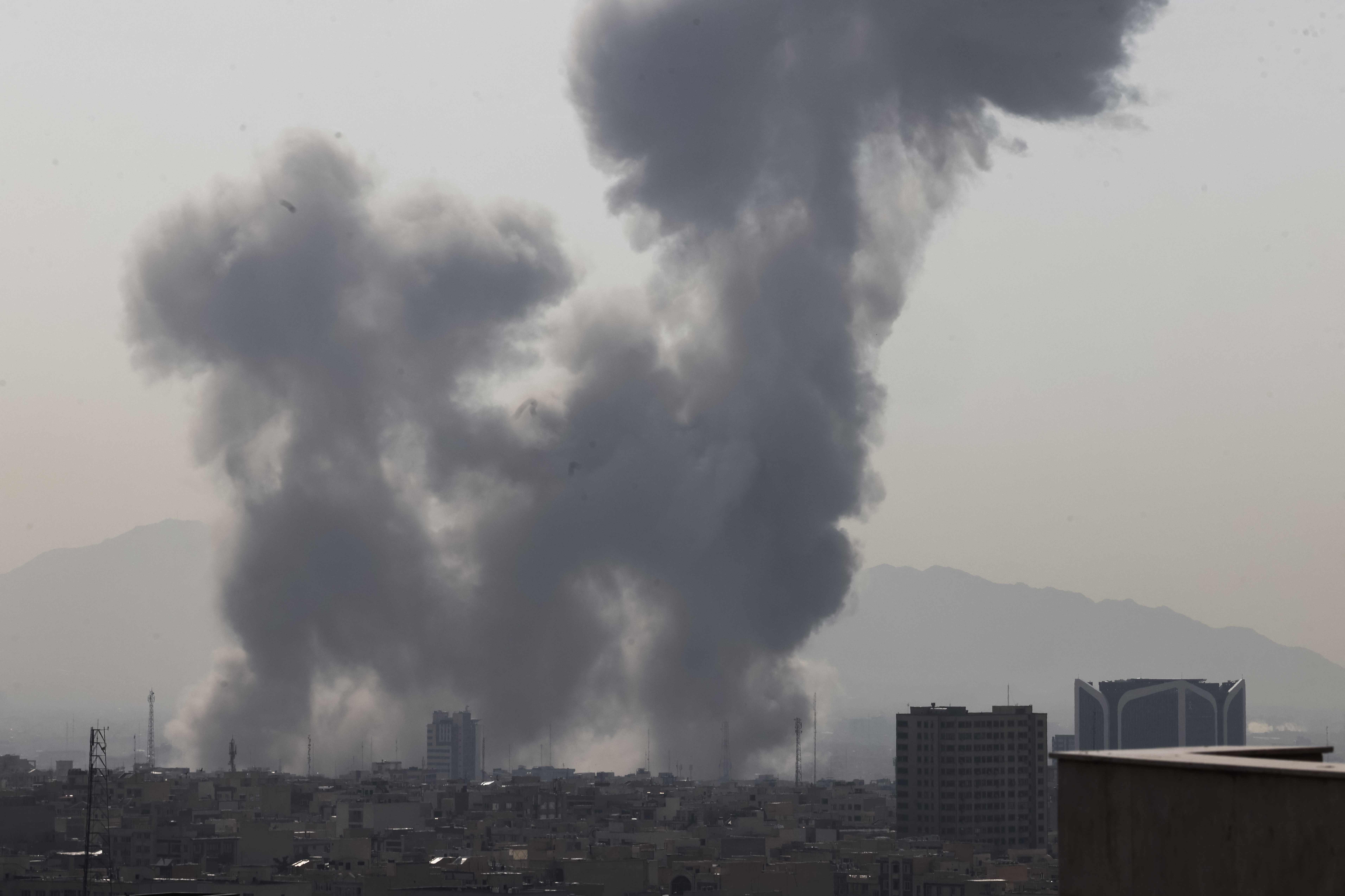 A plume of smoke rises following a reported explosion in Tehran on February 28, 2026. Two loud blasts were heard in Tehran on February 28 morning by AFP journalists, and two plumes of thick smoke were seen over the centre and east of the Iranian capital. Israel's defence ministry announced it had launched a "preemptive strike" on Iran as sirens sounded in Jerusalem and people across the country received phone alerts about an "extremely serious" threat. (Photo by ATTA KENARE / AFP)