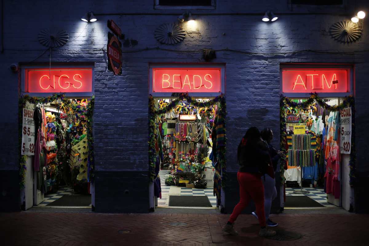 Pedestrians walk past a gift shop on Bourbon Street in the French Quarter of New Orleans. MUST CREDIT: Luke Sharrett/Bloomberg