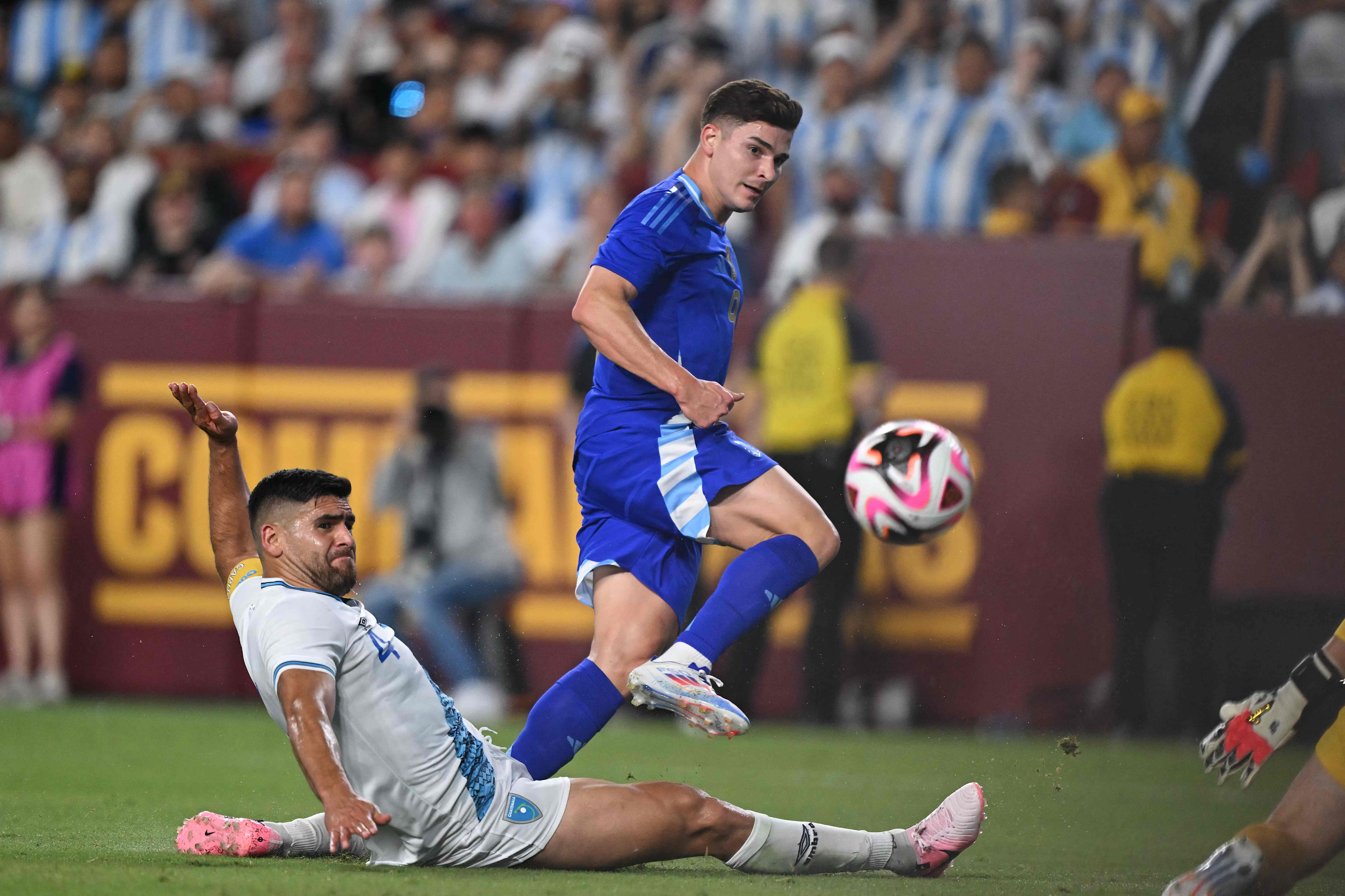 Argentina's forward #09 Julian Alvarez (R) takes a shot on goal as Guatemala's defender #04 Jose Carlos Pinto looks on during the international friendly football match between Guatemala and Argentina at Commanders Field in Greater Landover, Maryland, on June 14, 2024. (Photo by Andrew Caballero-Reynolds / AFP)