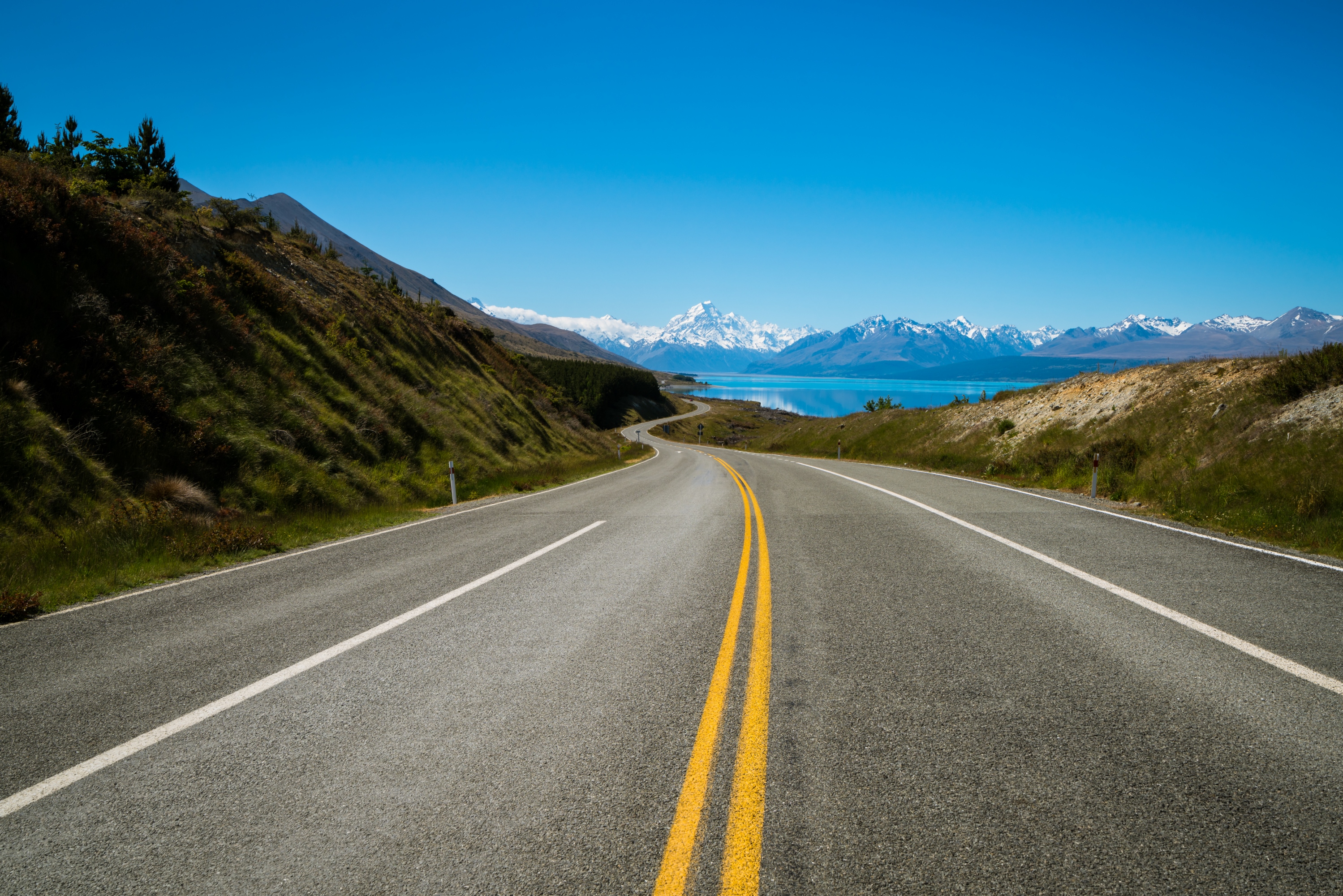 Road to Mount Cook, the highest mountain in New Zealand. A scenic highway drive along Lake Pukaki in Aoraki Mount Cook National Park, South Island of New Zealand. Shot at Highway 80 (Mt Cook Road).