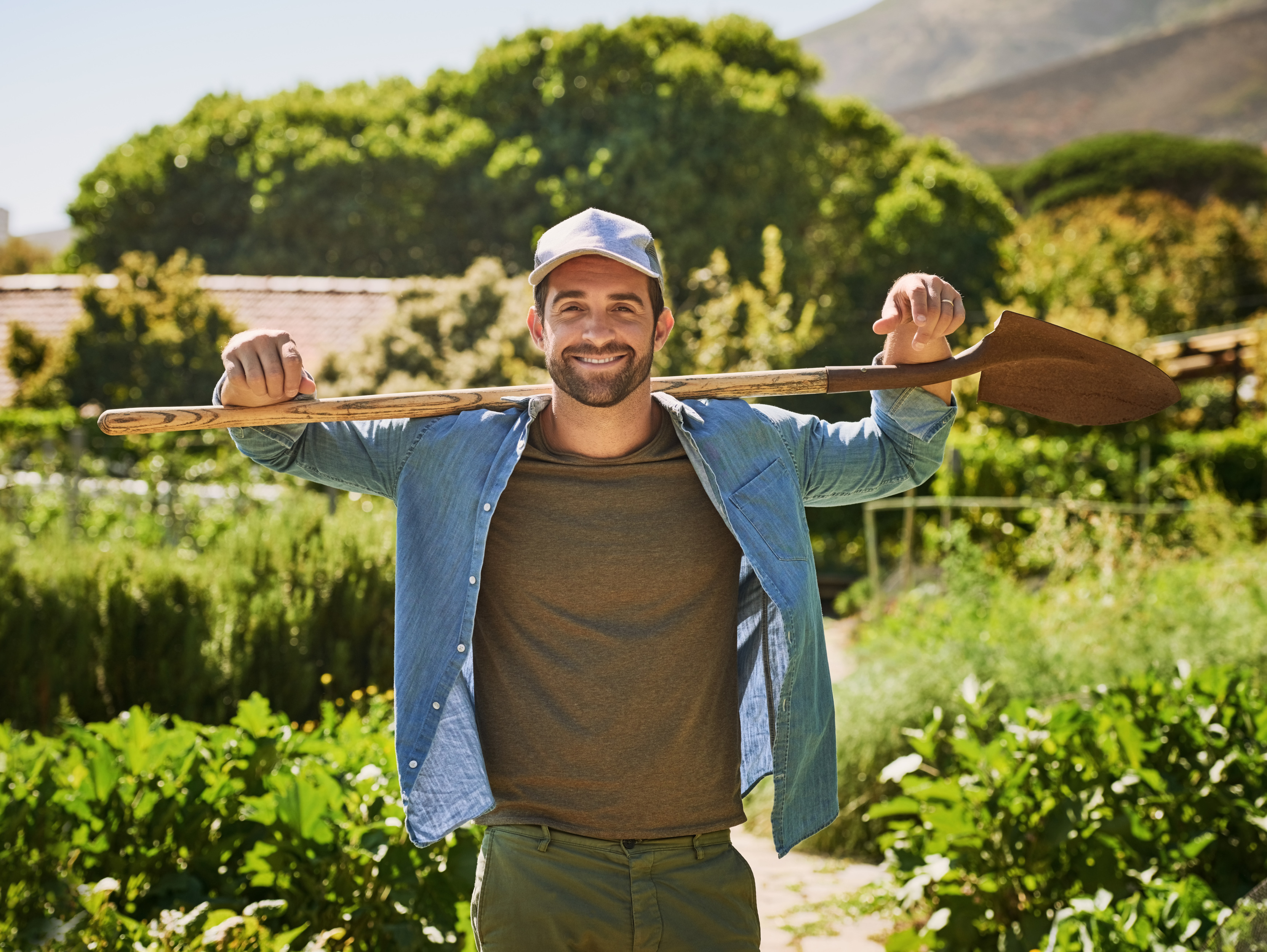 Man, farmer portrait and shovel outdoor, gardening and sustainability project for organic soil. Male person, agriculture and spade for plant harvest in nature, agro confidence and farm for growth.