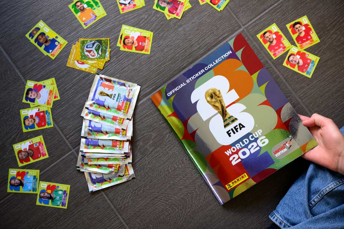 LAUSANNE (Switzerland), 12/05/2026.- A young collector opens a book before sticking Panini World Cup stickers of the Switzerland's soccer national team in the official Panini album of the FIFA World Cup 2026, in Lausanne, Switzerland, 12 May 2026. (Mundial de Fútbol, Suiza) EFE/EPA/LAURENT GILLIERON