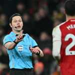 English referee Darren England gestures during the English Premier League football match between Arsenal and Aston Villa at the Emirates Stadium in London on December 30, 2025. (Photo by Ben STANSALL / AFP) / RESTRICTED TO EDITORIAL USE. No use with unauthorized audio, video, data, fixture lists, club/league logos or 'live' services. Online in-match use limited to 120 images. An additional 40 images may be used in extra time. No video emulation. Social media in-match use limited to 120 images. An additional 40 images may be used in extra time. No use in betting publications, games or single club/league/player publications. /