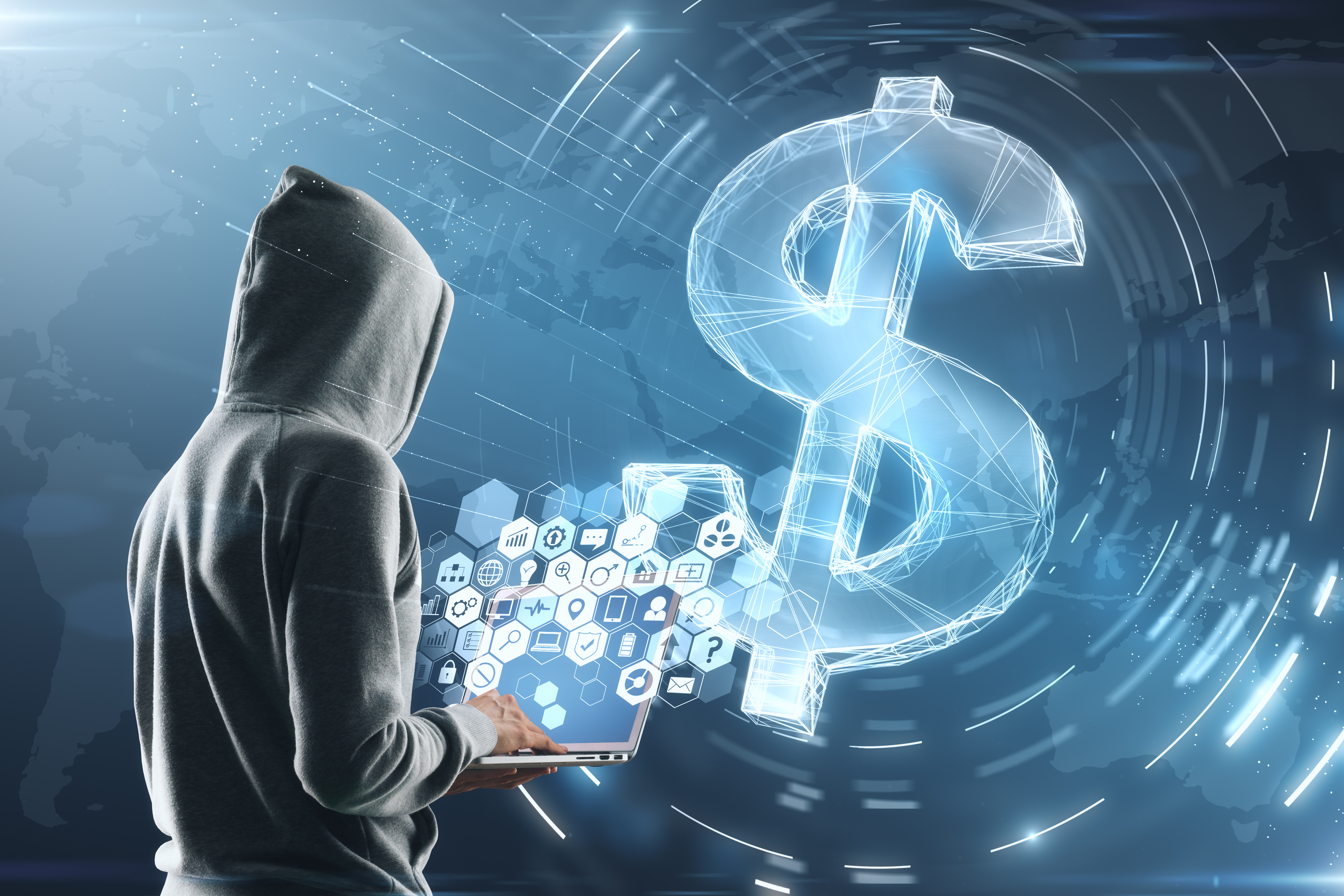 cyber attack concept with hacker in grey hoody with laptop and multimedia icons on screen. digital dollar sign background.