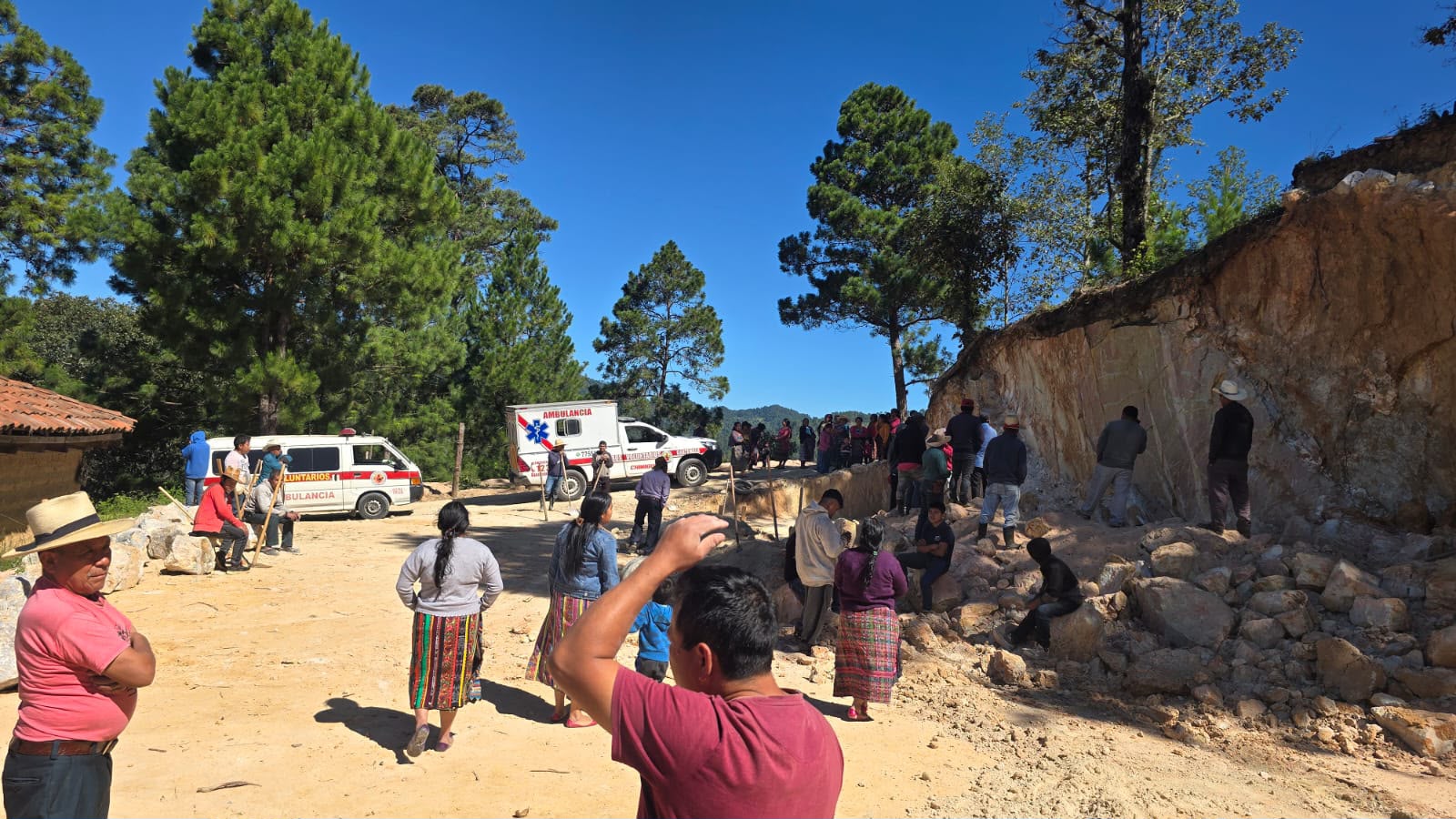 Bomberos Voluntarios de la 104 Compañía y vecinos de la comunidad participan en las labores de rescate de dos albañiles que quedaron soterrados tras el colapso de un paredón en Sibacá, Quiché. (Foto Prensa Libre: CVB)