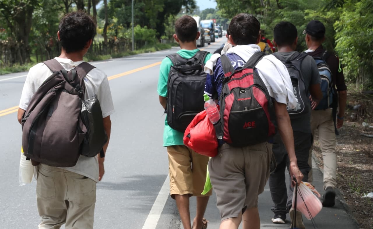 Un grupo de migrantes hondureños avanza por Morales, Izabal, en su recorrido hacia México. (Foto Prensa Libre: Moisés Xec)