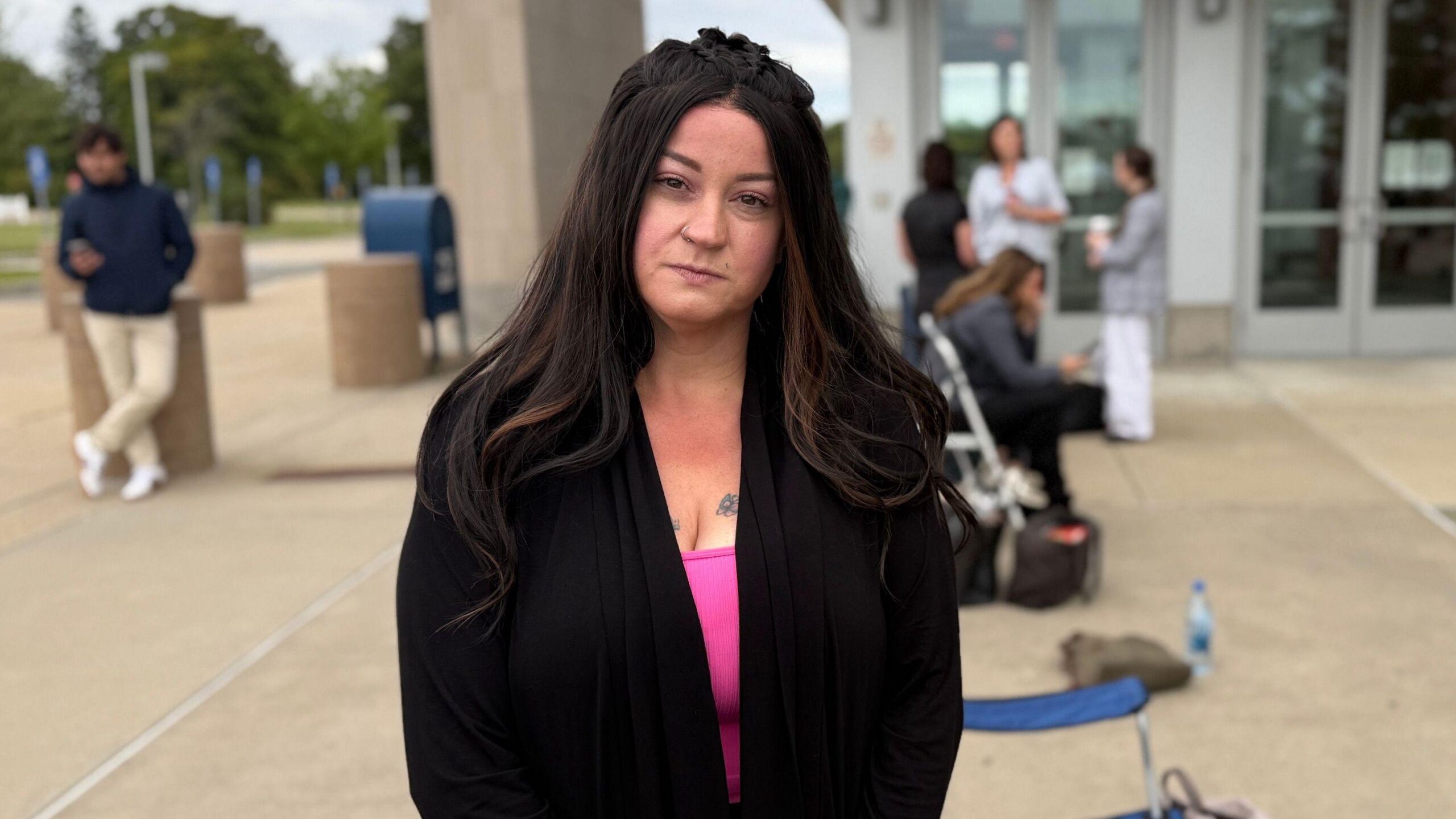 This composite image shows supporters for and against Lindsay Clancy holding signs outside the courthouse. One sign reads "compassion before judgement" and another reads "first degree murder let's go"