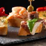 Assortment of Spanish pintxos on wooden table