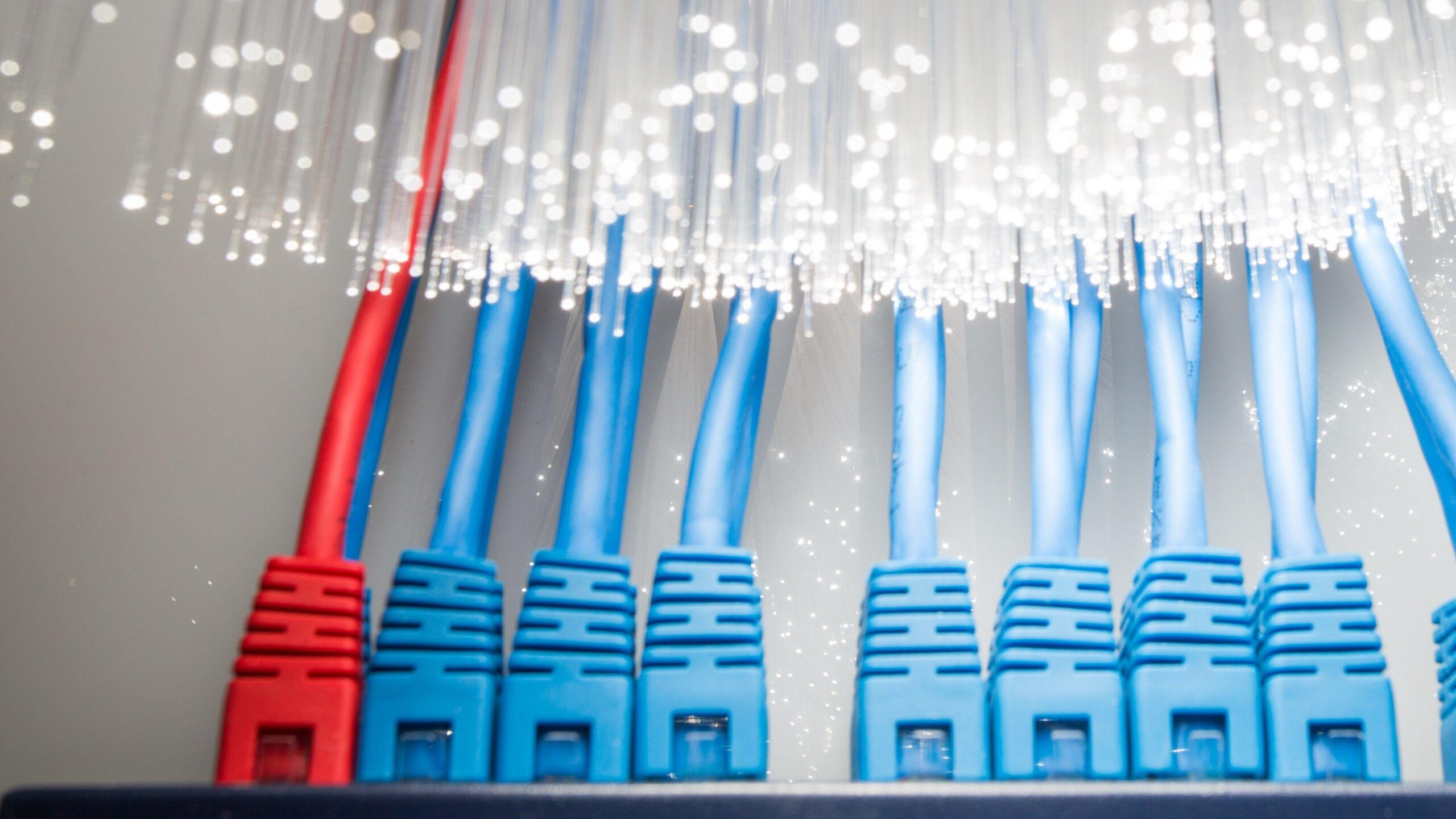 una mano desconecta un cable. Se ven varios artefactos tecnológicos con distintos cables conectados.
