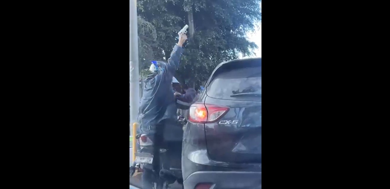 Captura de pantalla del momento en que presuntos asaltantes en motocicleta atacan a los ocupantes de un vehículo en la zona 7 capitalina, donde se reportan forcejeos y disparos, sin personas heridas. (Foto Prensa Libre)