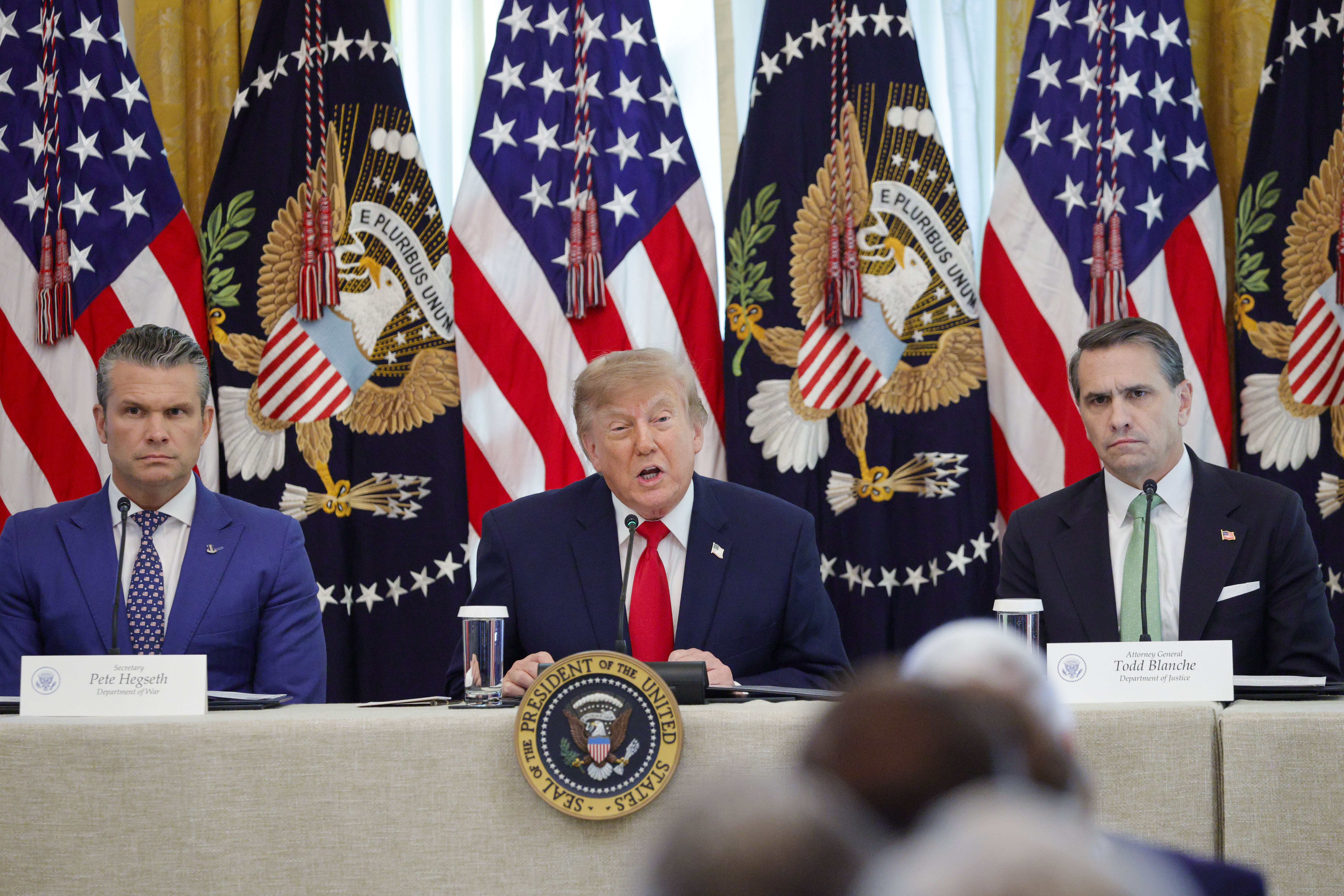 US President Donald J. Trump, with Secretary of Defense Pete Hegseth (L) and Attorney General Todd Blanche (R), delivers remarks during a roundtable on Protecting American Families and Seniors from Cybercrime in the East Room of the White House in Washington, DC USA, 21 October 2026. (Shawn Thew/Pool/FTWP)