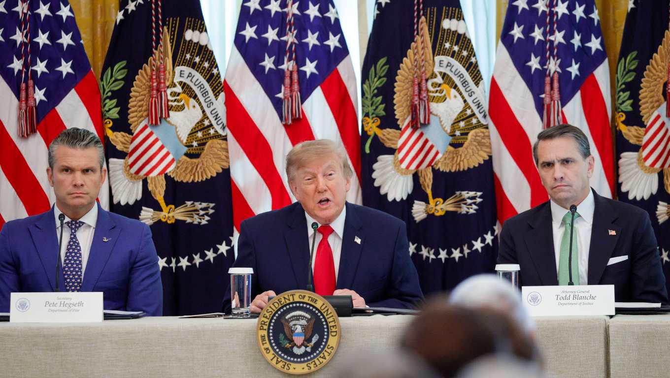 US President Donald J. Trump, with Secretary of Defense Pete Hegseth (L) and Attorney General Todd Blanche (R), delivers remarks during a roundtable on Protecting American Families and Seniors from Cybercrime in the East Room of the White House in Washington, DC USA, 21 October 2026. (Shawn Thew/Pool/FTWP)
